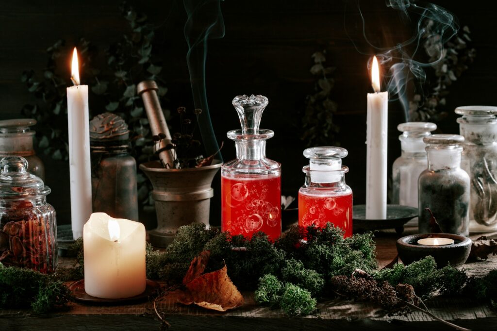 Witchcraft still life concept with potion, herbs ingredients candles and magical equipment